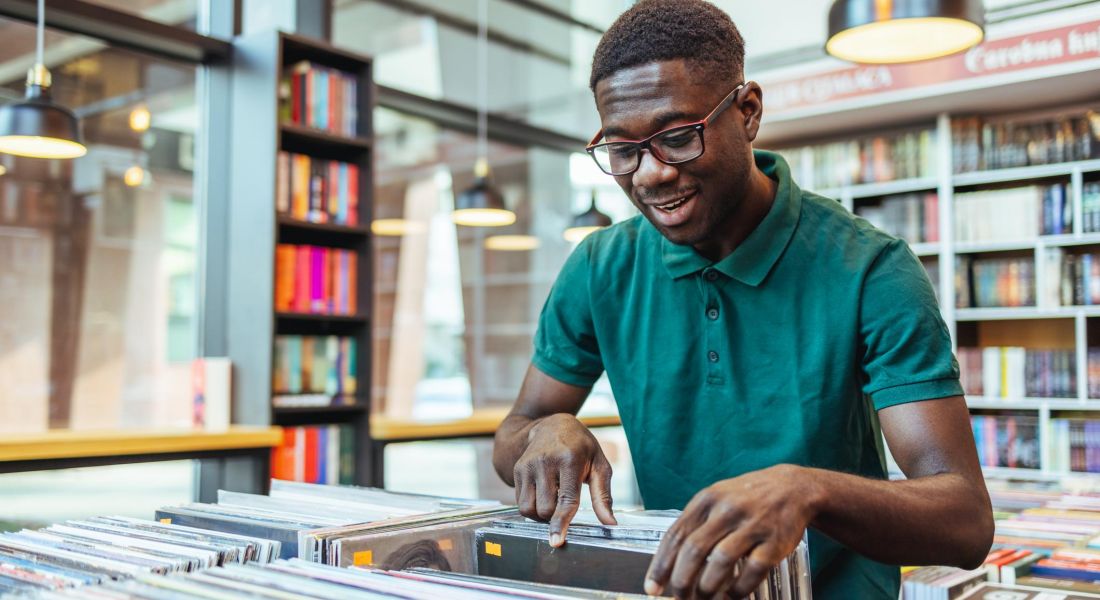 Man looking through a collection of records at a vintage store