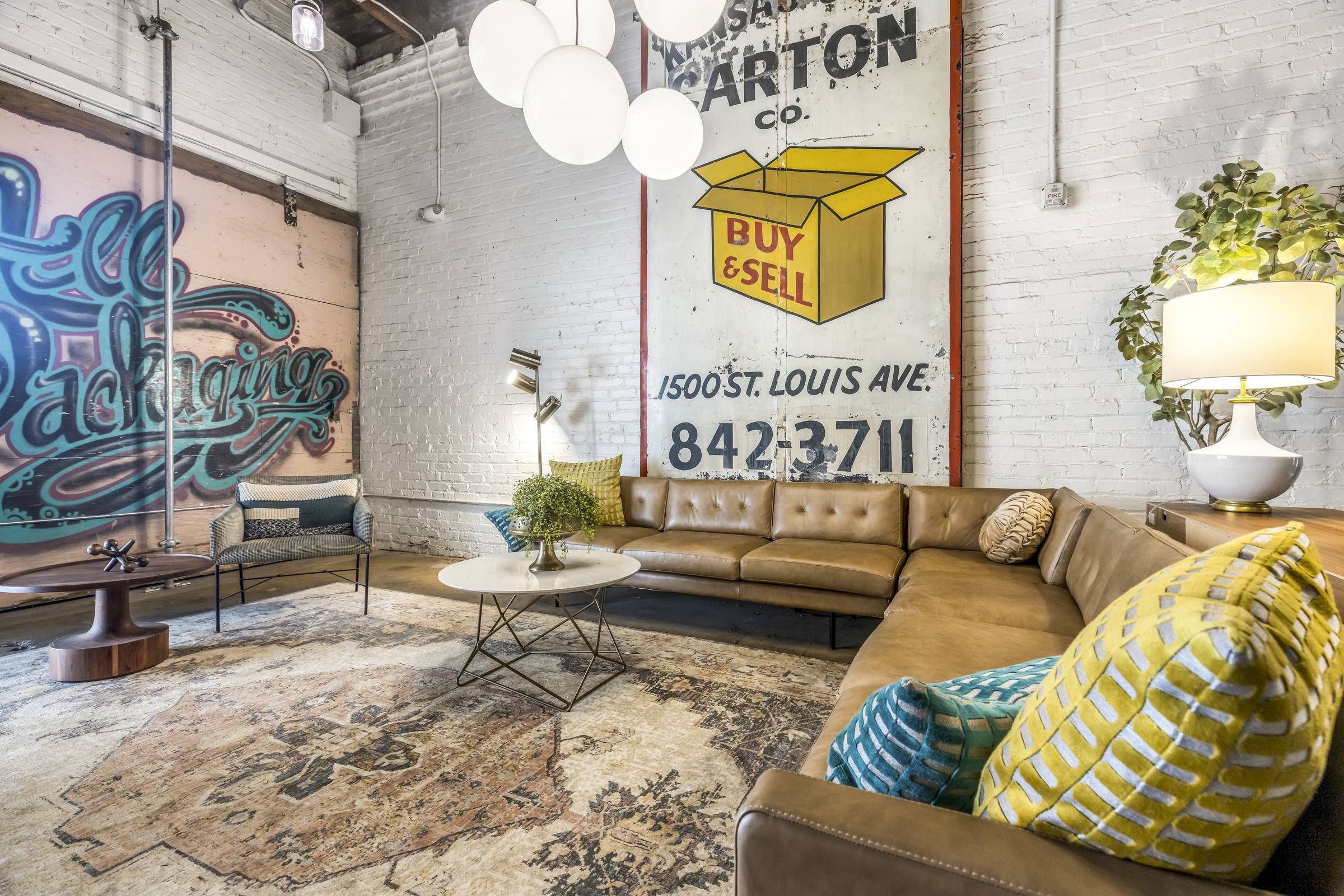 West Bottoms Flats apartments resident lounge with urban core features like exposed brick walls, concrete floors, and high ceilings