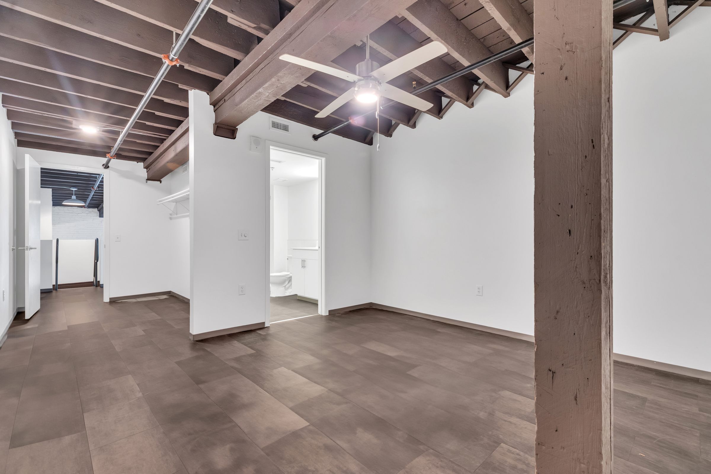 West Bottoms Flats apartment living room with urban core features like raft ceilings and bright white walls and open floor plan