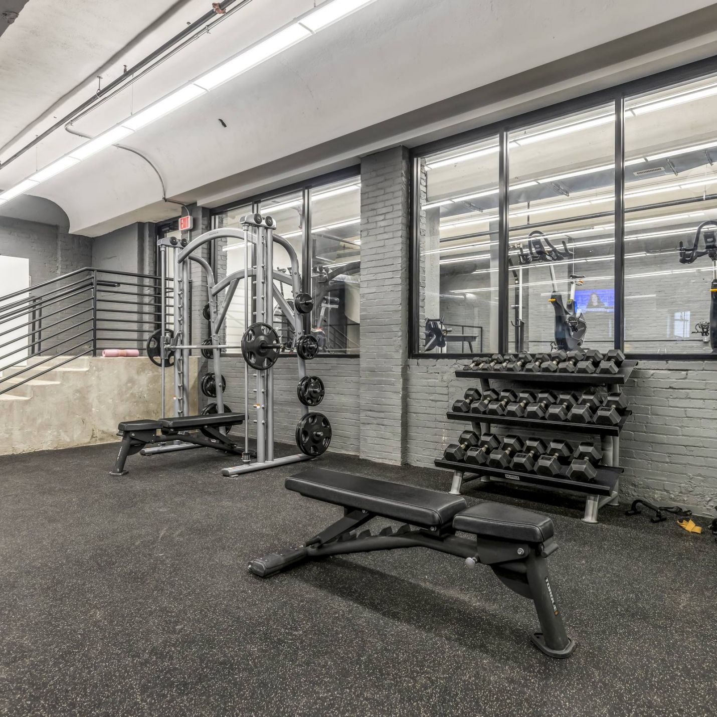 West Bottoms Flats apartments resident fitness center with weights, benches, and strength equipment 
