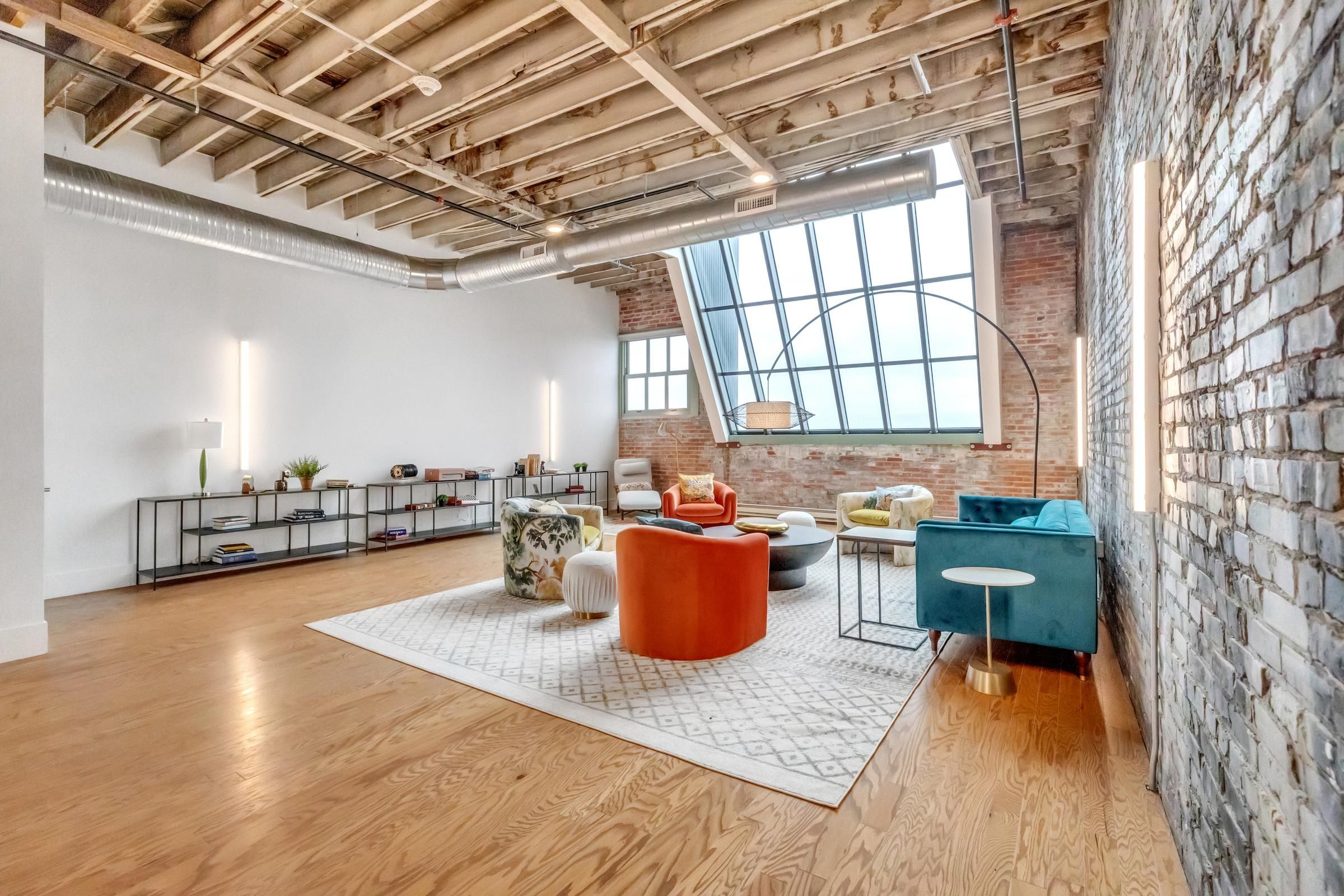 West Bottoms Flats apartments resident lounge with urban core features like exposed brick walls, concrete floors, and high ceilings