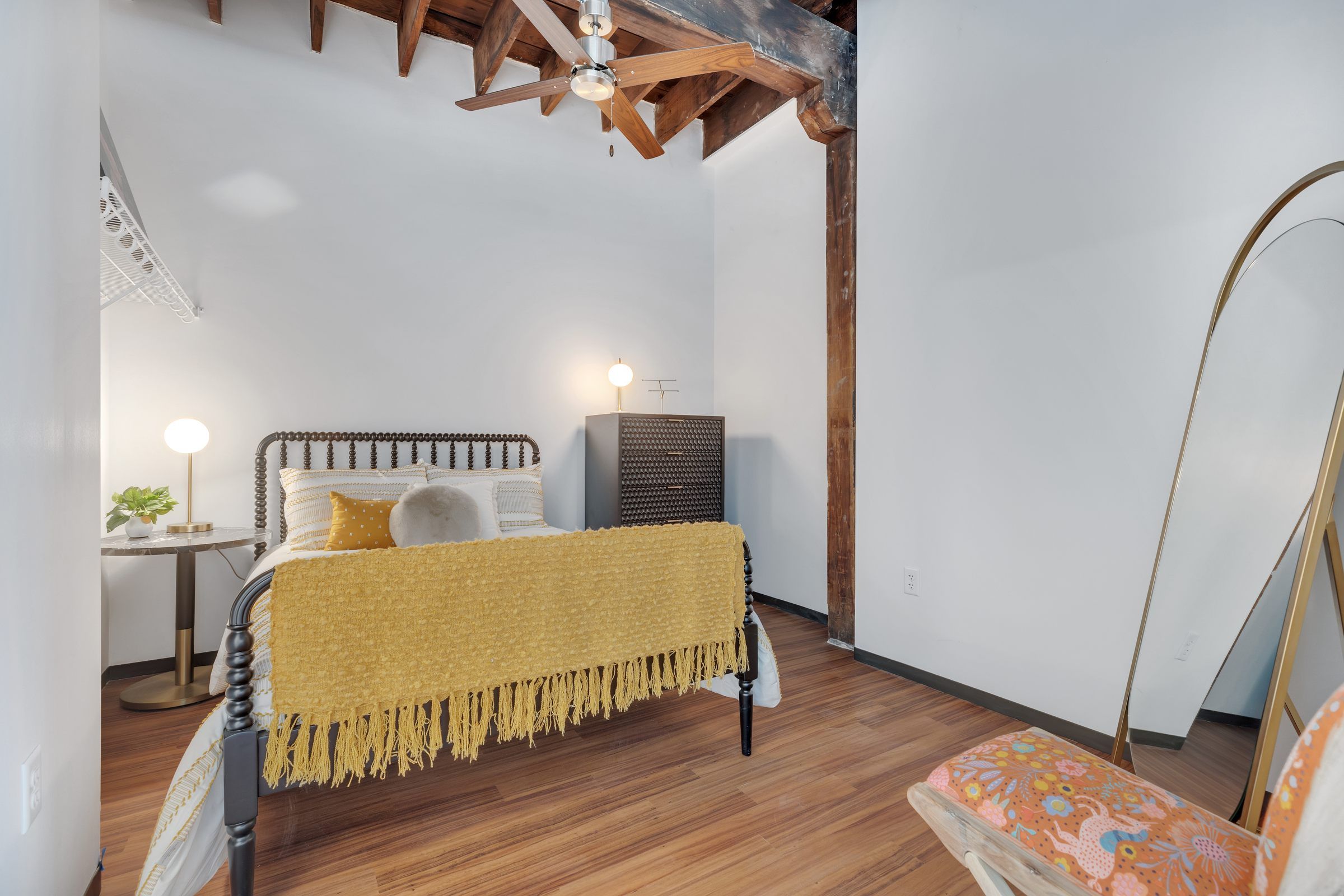 West Bottoms Flats apartments cozy bedroom plan including open raft ceilings, wood plank flooring and vintage timbers