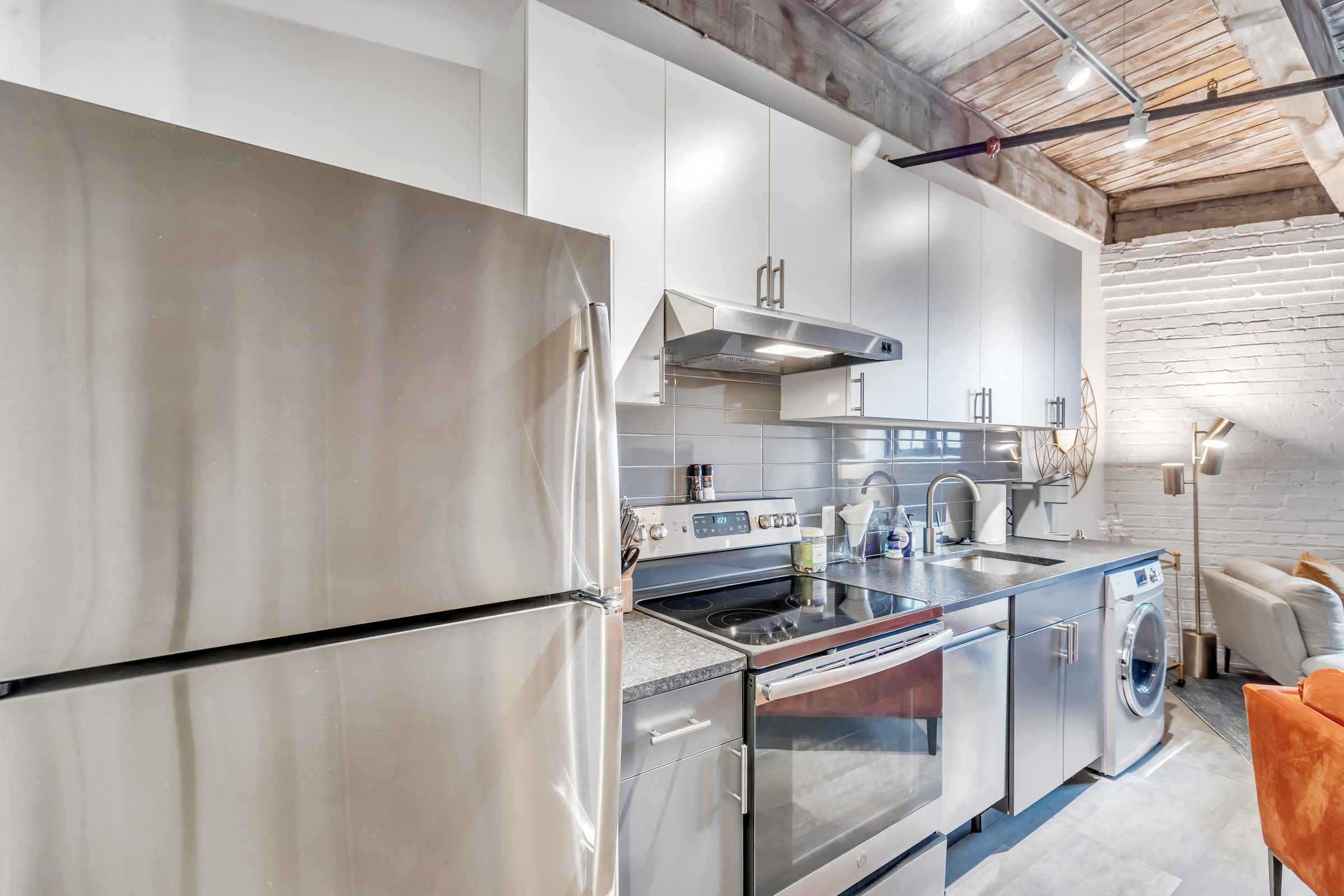 West Bottoms Flats apartments modern kitchen with white cabinets and stainless steel appliances