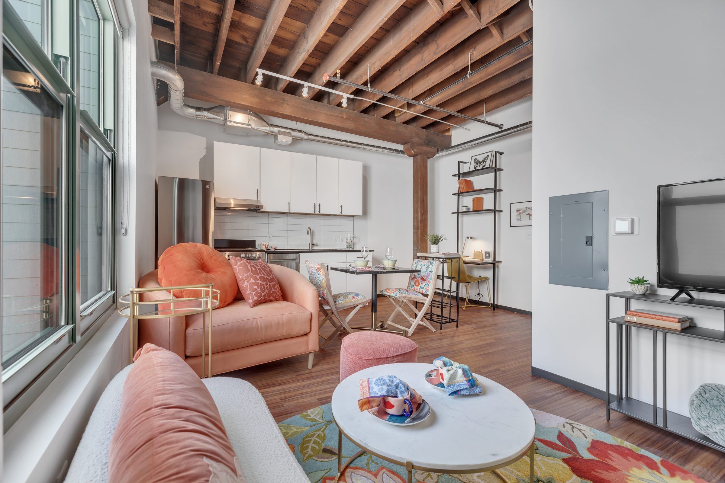 West Bottoms Flats apartments furnished open floor plan including open raft ceilings, wood plank flooring and very large windows 