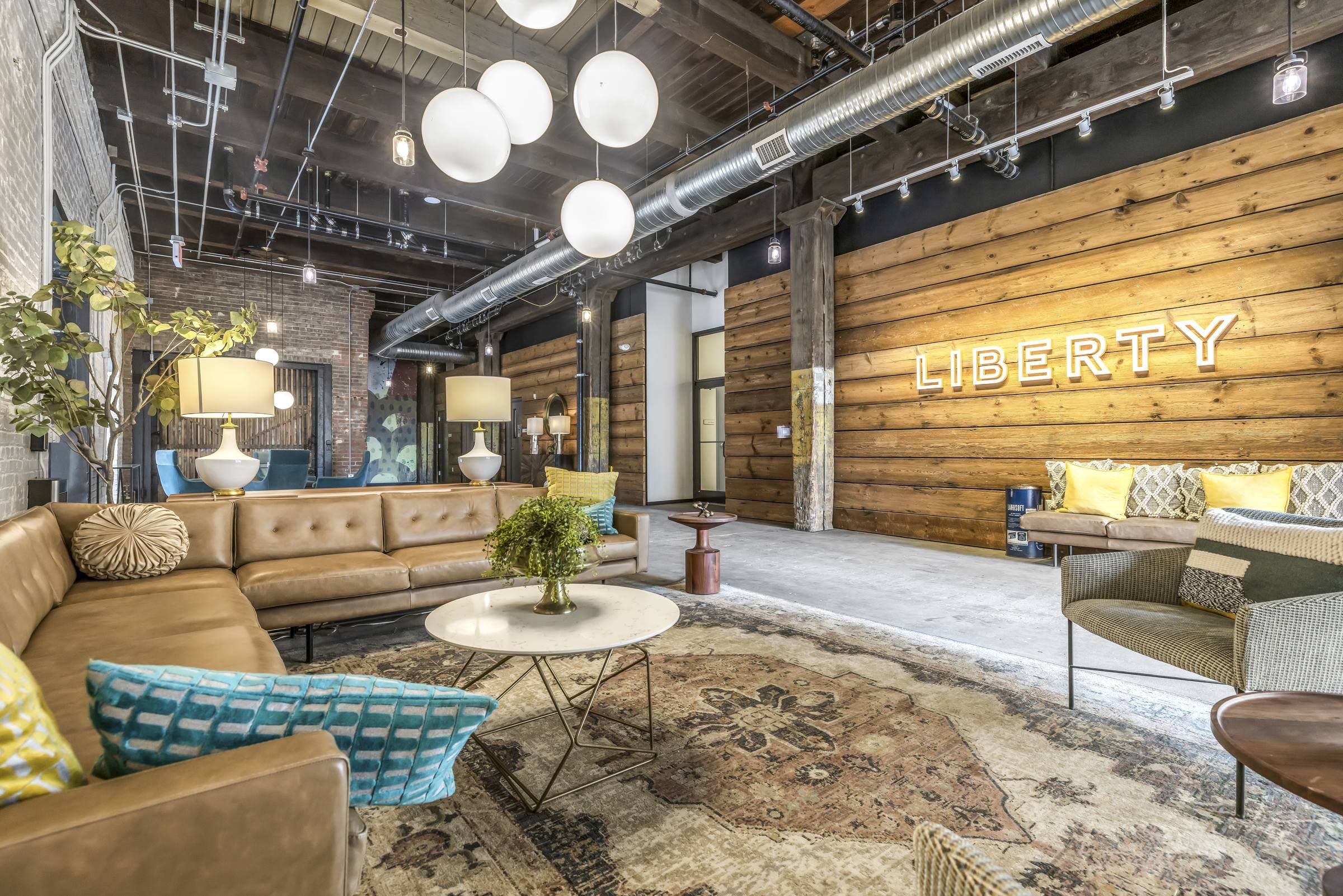 West Bottoms Flats apartments Liberty building lobby featuring large seating area with hanging lights and modern furniture
